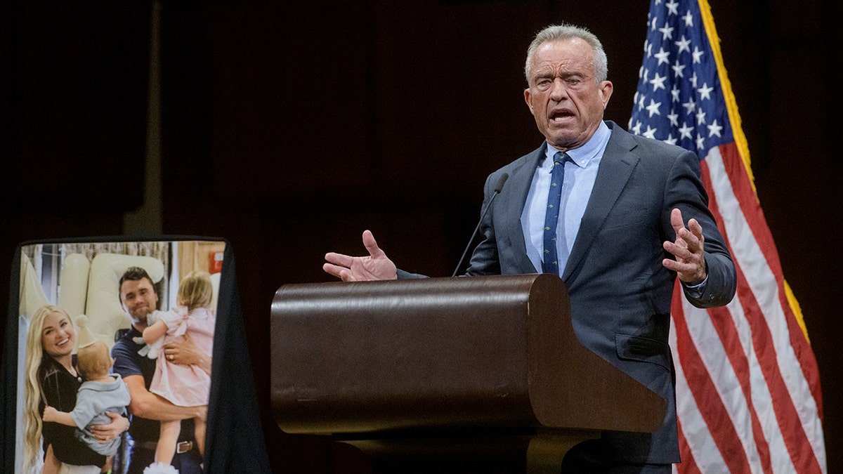 Robert F. Kennedy Jr. in dark suit speaks at Charlie Kirk vigil