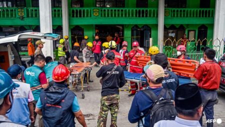 Two pulled from Indonesia school collapse as rescuers race against time
