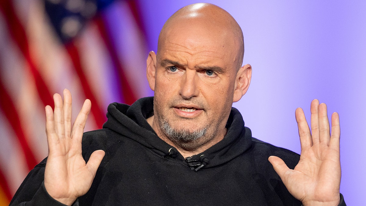 Sen. John Fetterman of Pennsylvania with his hands raised