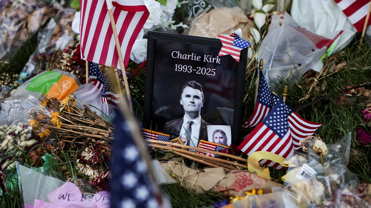 An image of Charlie Kirk surrounded by American flags and other mementos.