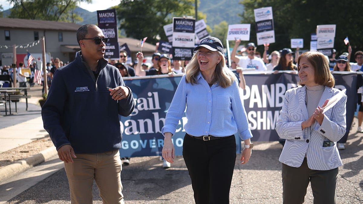 Jay Jones and Abigail Spanberger march in parade