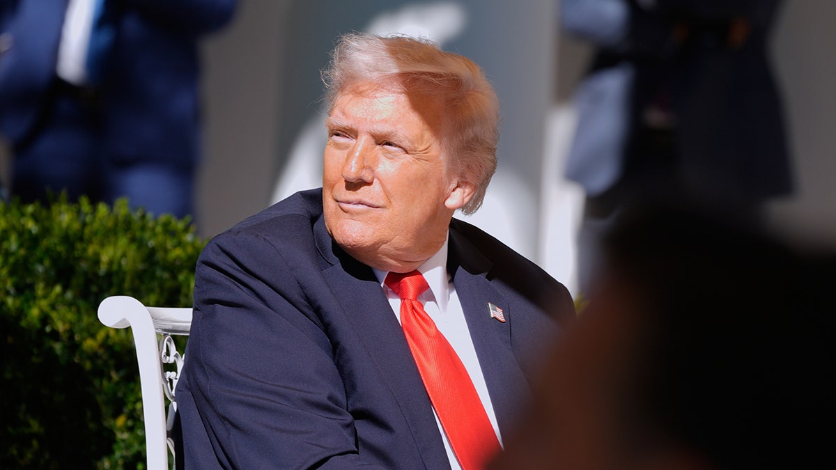 President Donald Trump listens to speech from Senate Majority Leader John Thune, R-S.D.