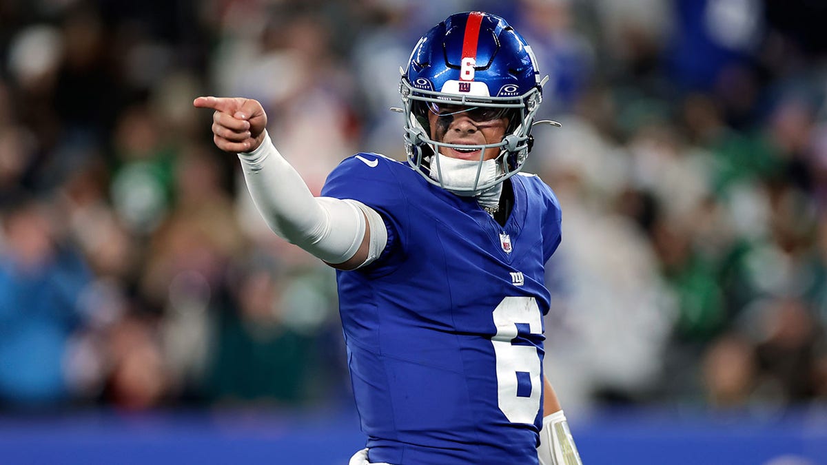 Jaxson Dart points during a touchdown