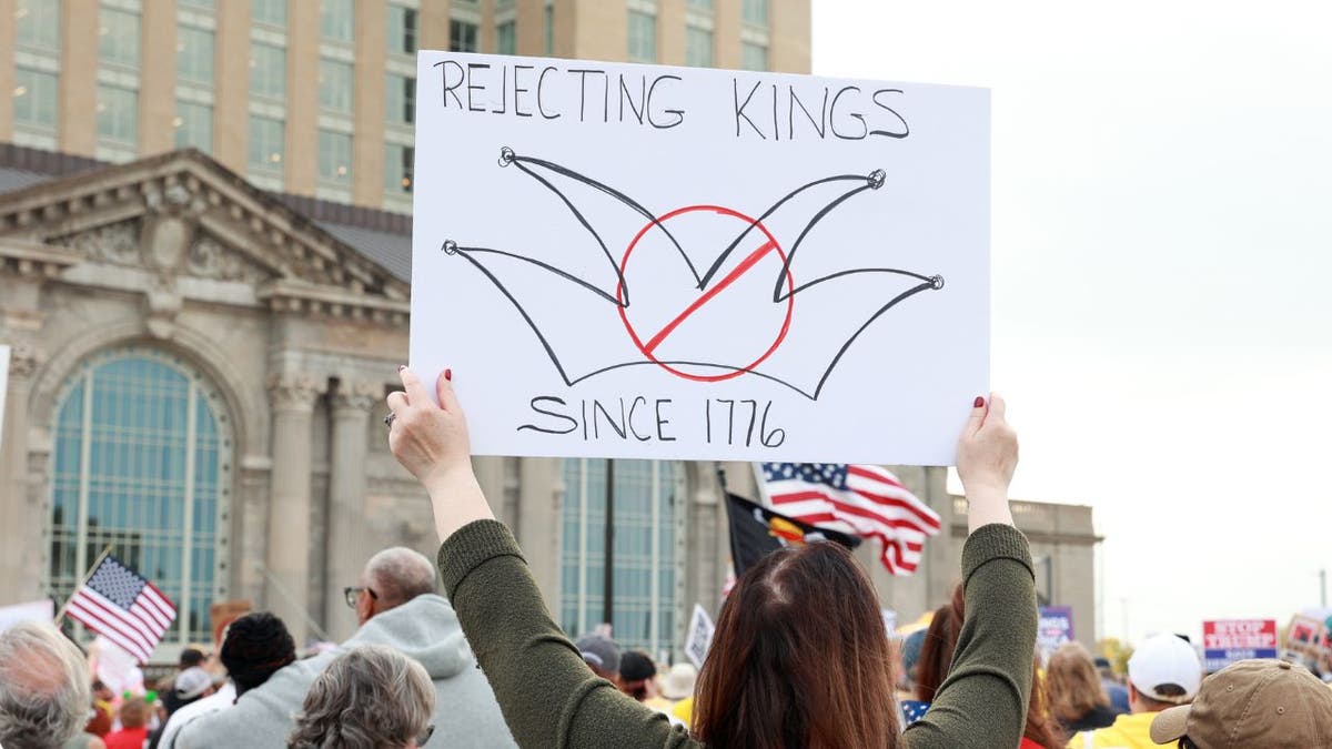 A protester appears at a "No Kings" rally