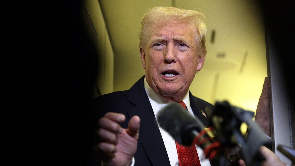 President Trump speaks to reporters aboard Air Force One.