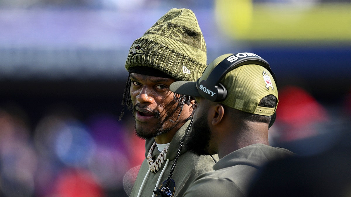 Lamar Jackson stands on sideline