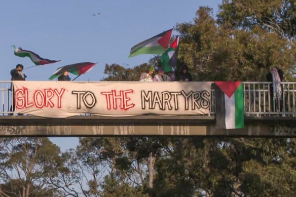 A banner draped over a pedestrian overpass on Bell Street in Preston bears the message “glory to the martyrs”. 