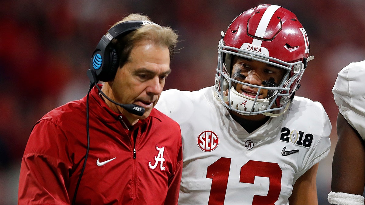Nick Saban speaks with Tua Tagovailoa