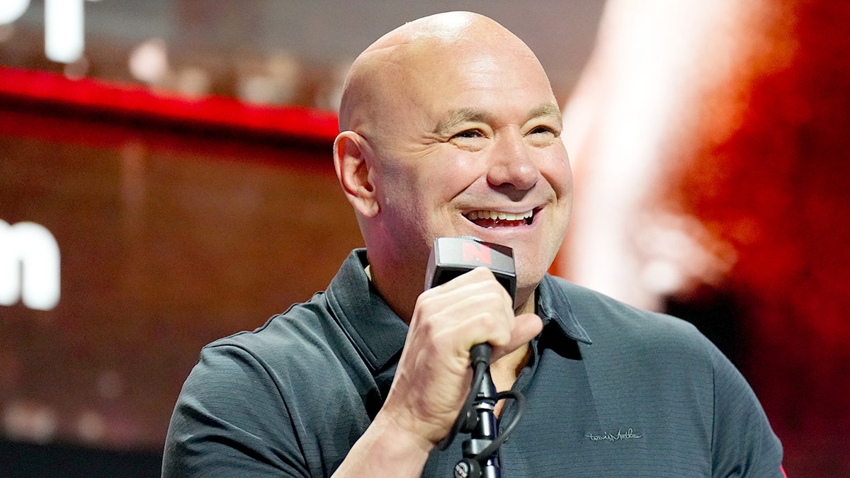 UFC CEO Dana White speaking into a microphone on a stage