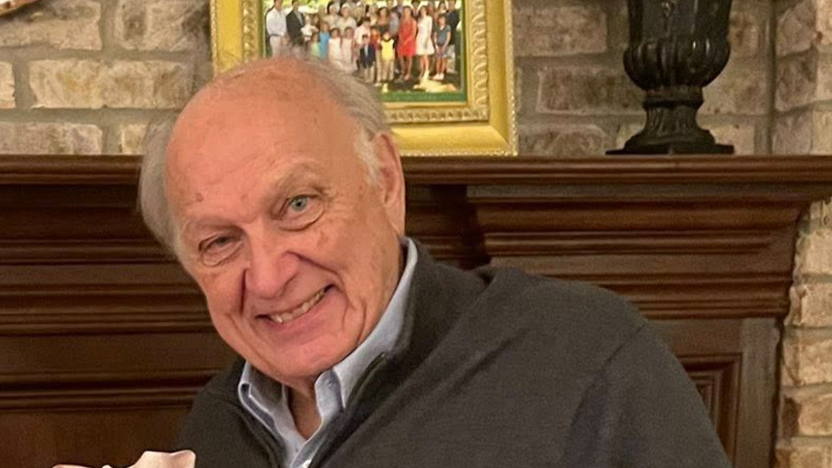 David Ong smiles in family photo taken inside a home.