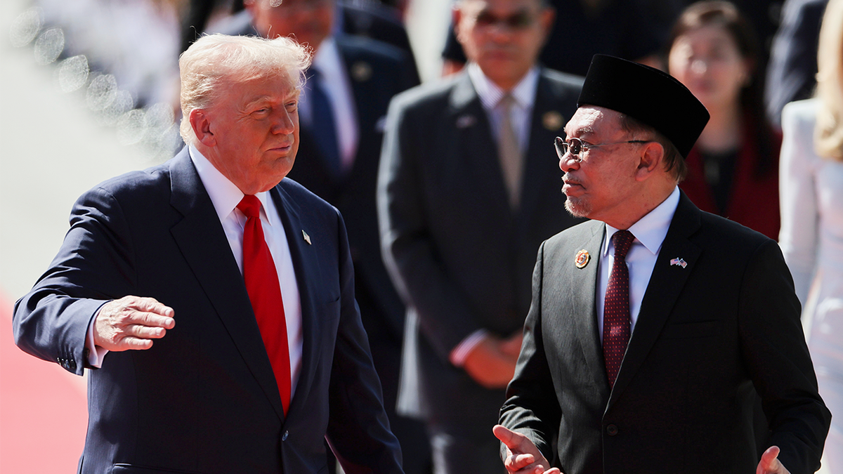 U.S. President Donald Trump talks with Malaysia Prime Minister Anwar Ibrahim