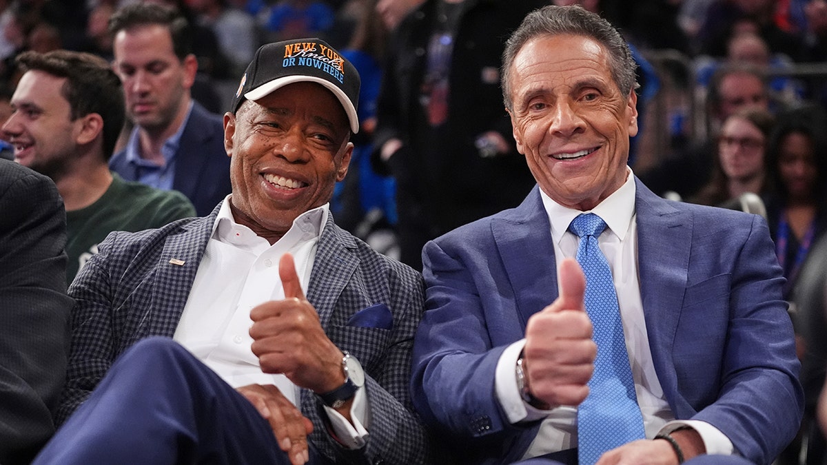 Eric Adams and Andrew Cuomo give thumbs up during basketball game