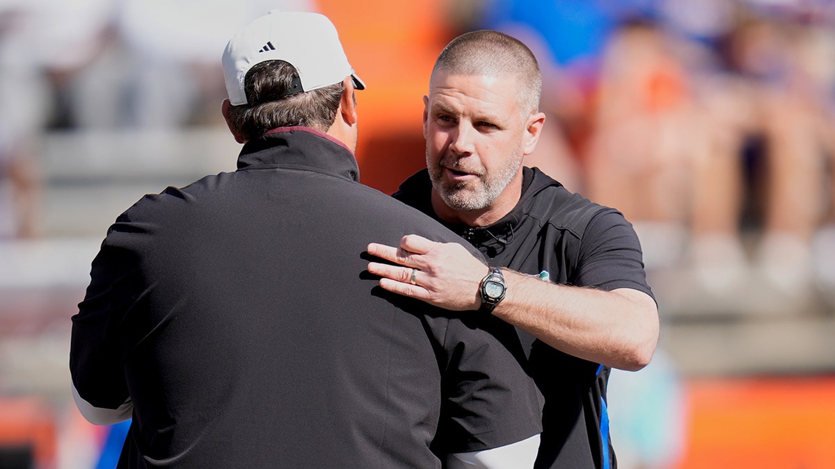 Billy Napier and Jeff Lebby hug it out