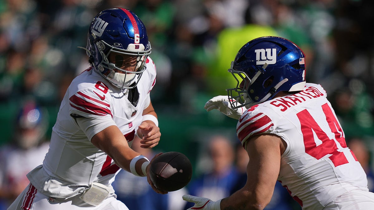 Cam Skattebo takes ball from Jaxson Dart