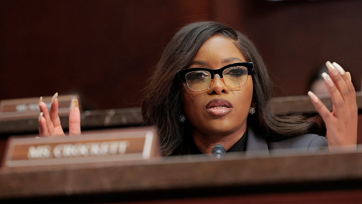 Rep. Jasmine Crockett with her hands raised.