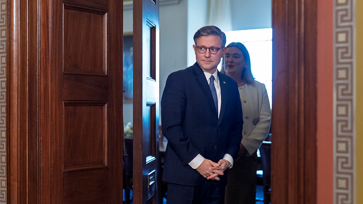Mike Johnson standing in a congressional doorway