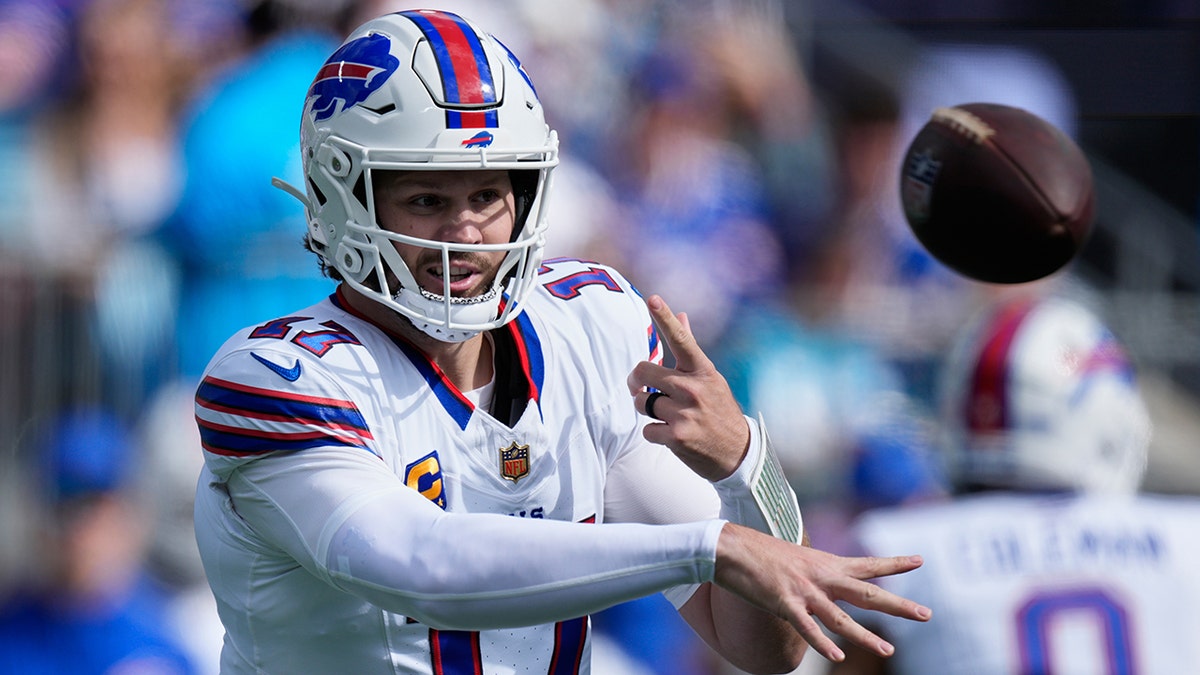 Josh Allen tosses the football