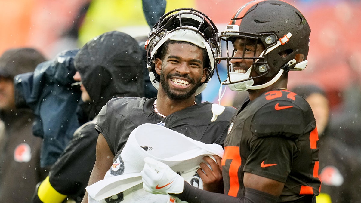 Shedeur Sanders smiles on the sidelines