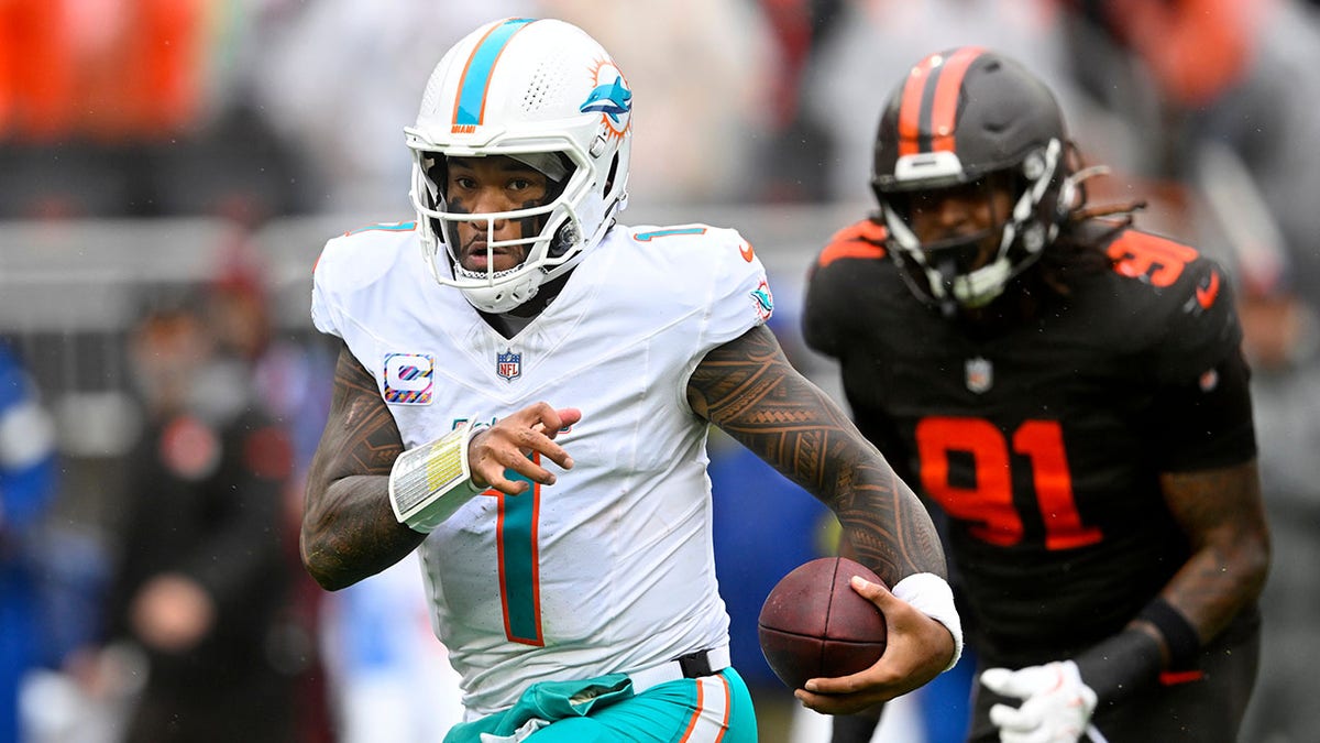 Tua Tagovailoa scrambles with the ball