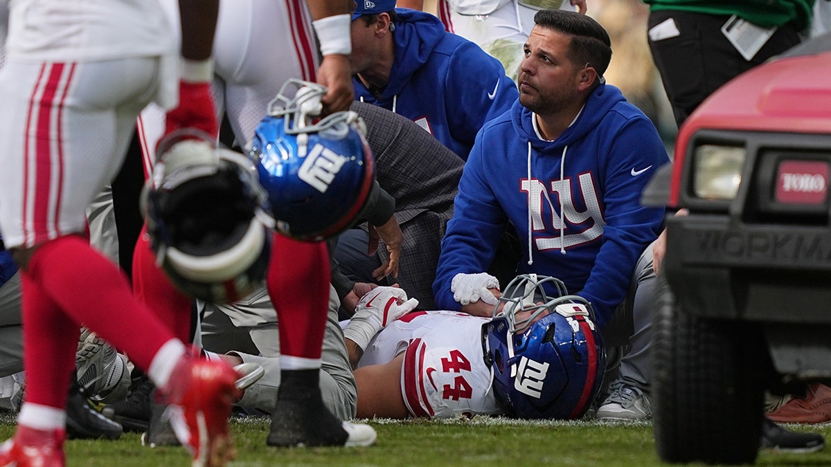 Cam Skattebo on his back in pain