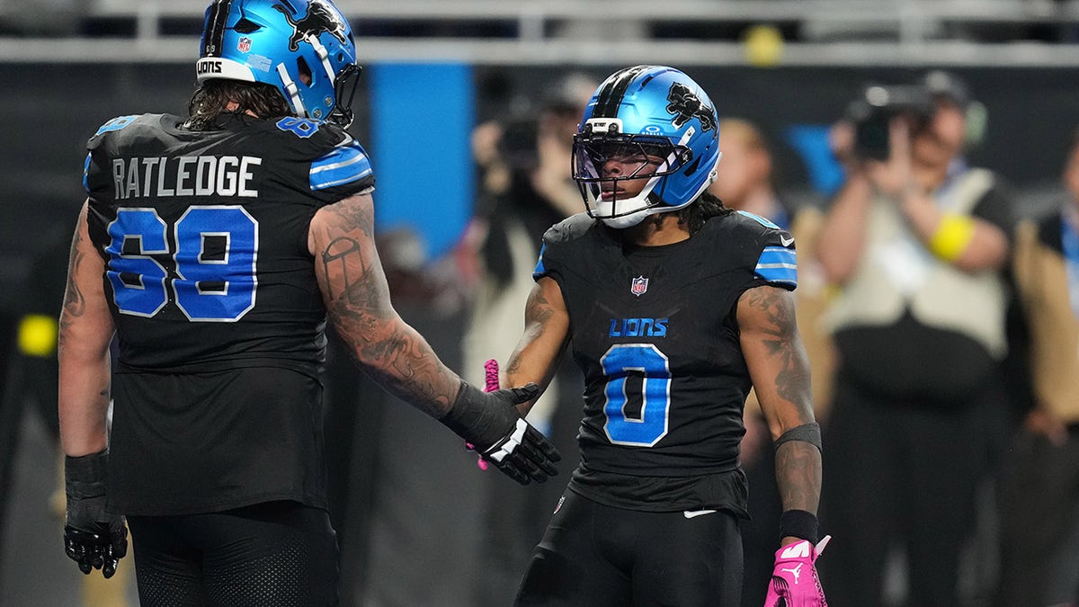 Jahmyr Gibbs with teammate Tate Ratledge