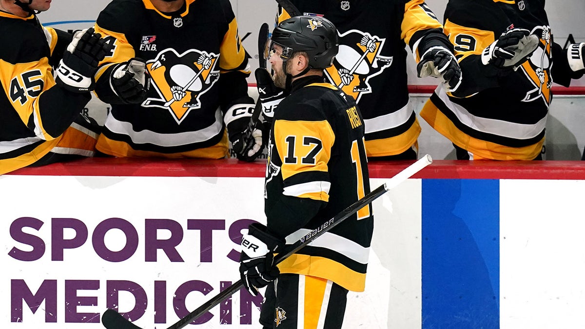 Bryan Rust shakes hands with his teammates