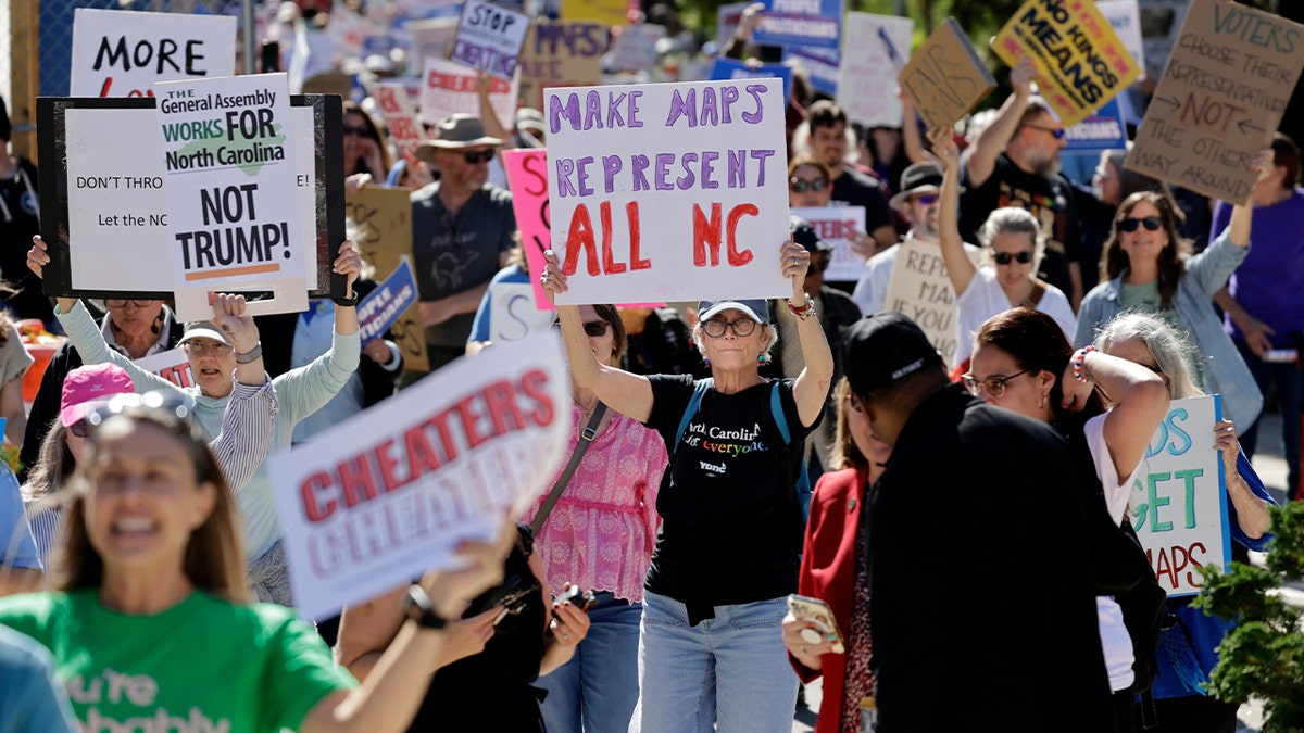 large group of marchers holding signs