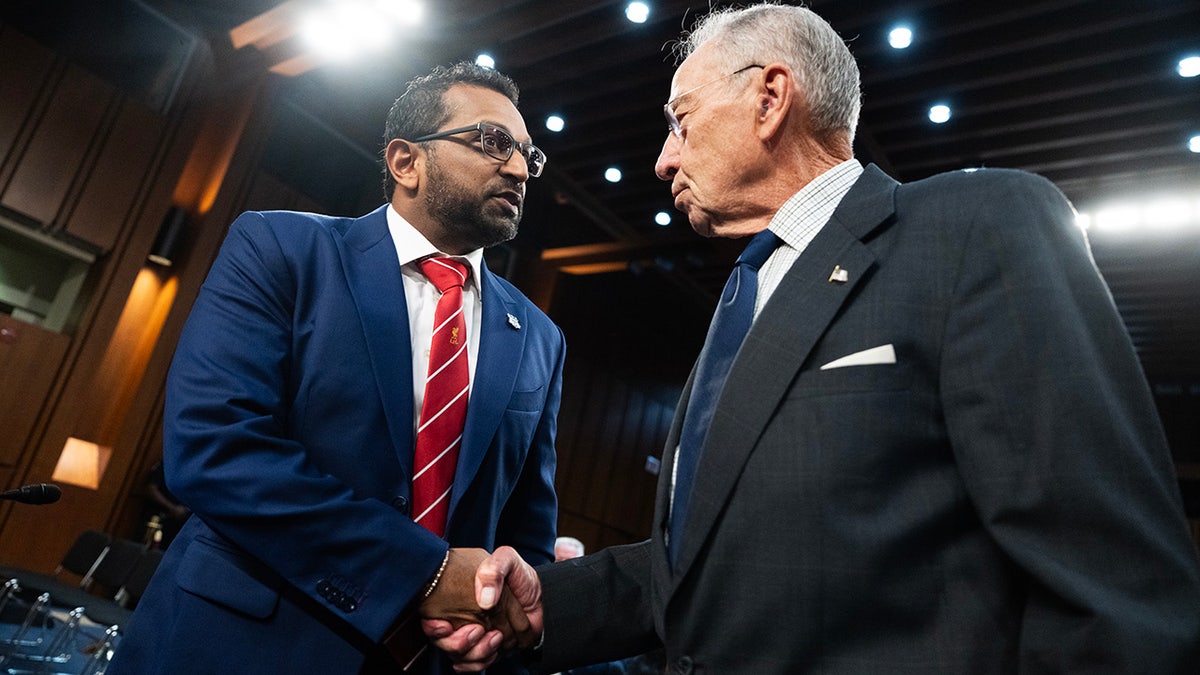 Patel and Grassley shaking hands