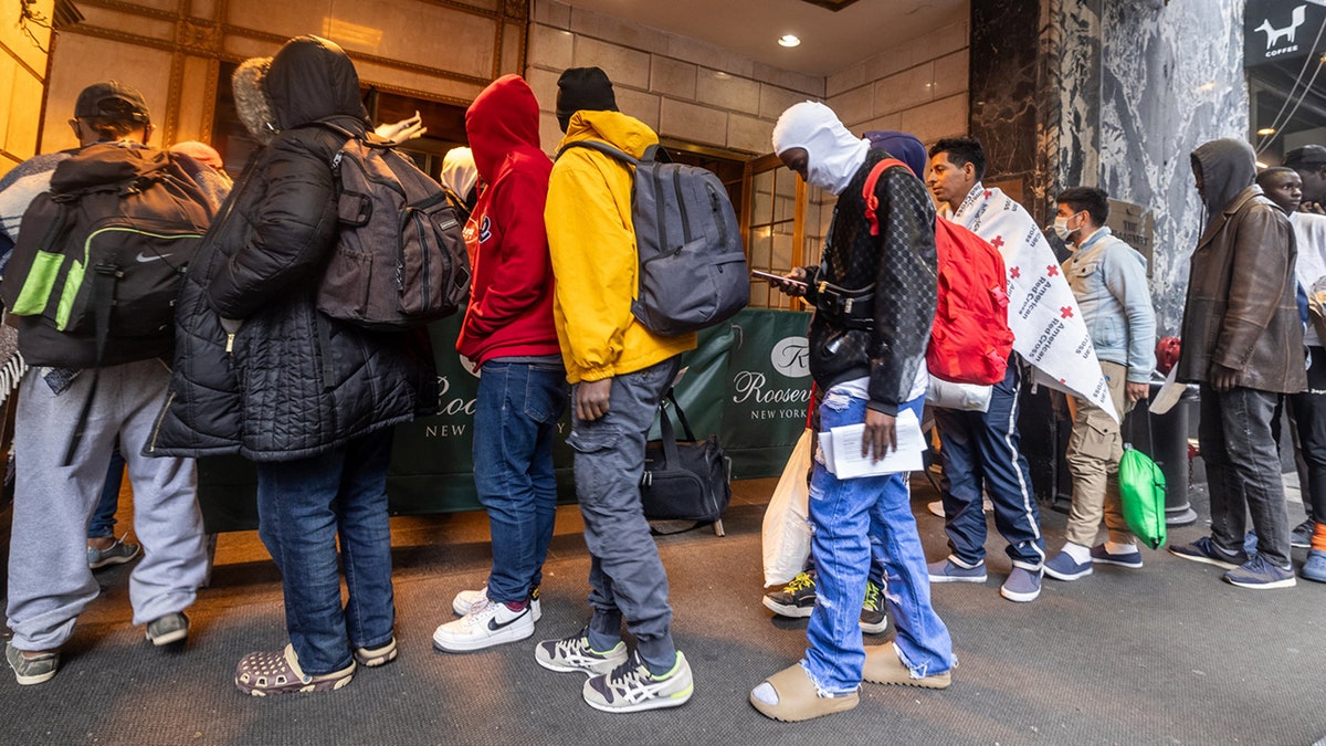 Migrants line up at Roosevelt Hotel