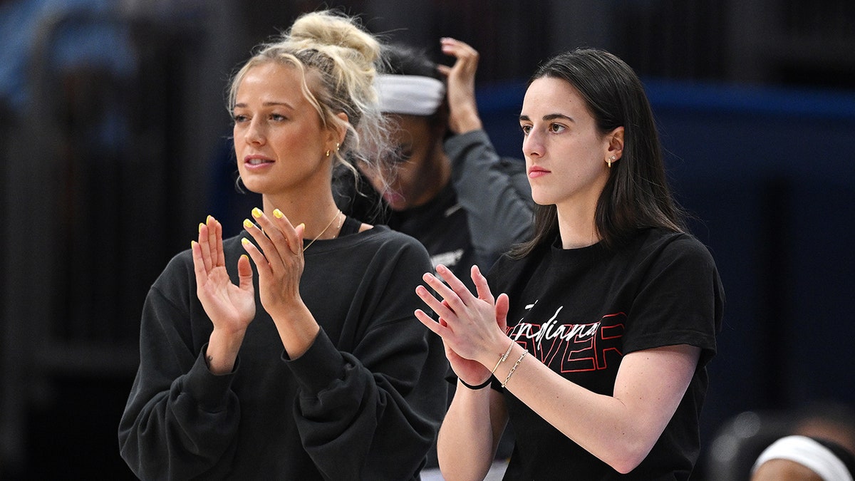 Sophie Cunningham (8) and Caitlin Clark courtside