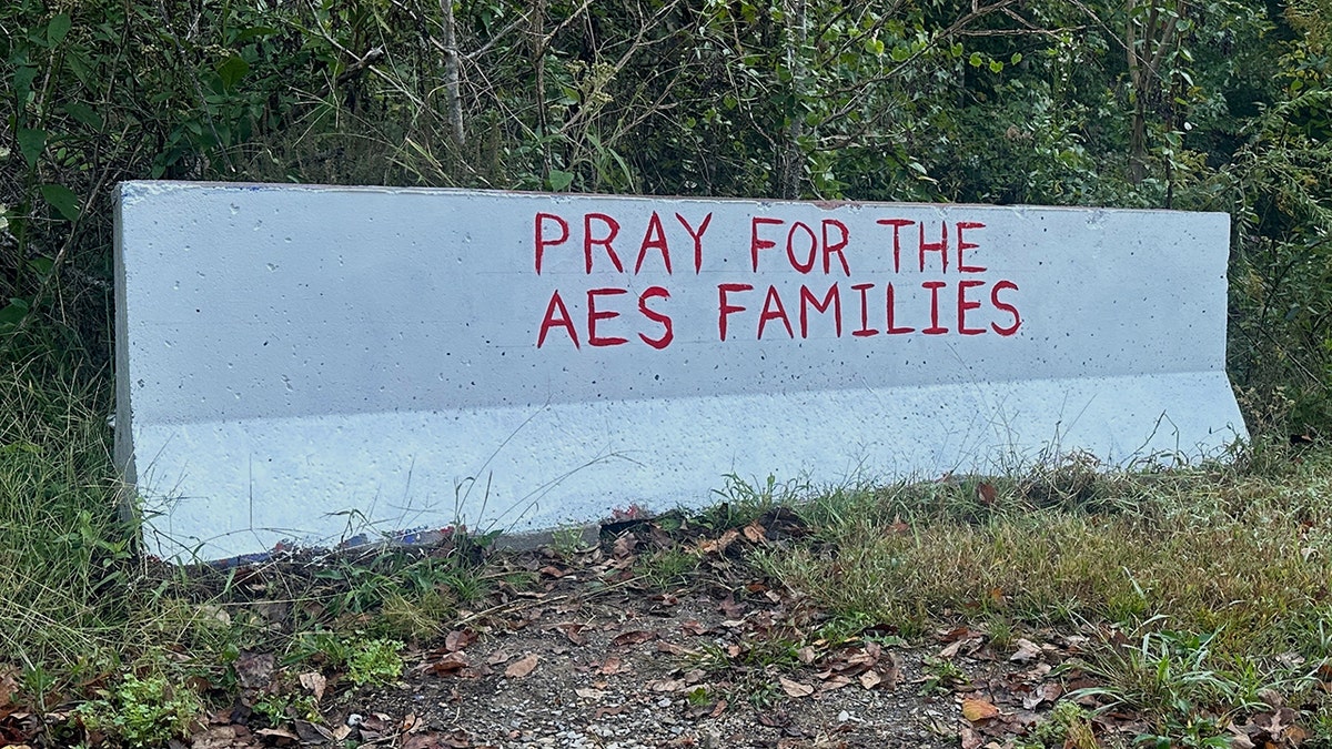 Sign says "Pray for the AES families" following an explosion at the Accurate Energetic Systems plant near Bucksnort, Tennessee, on Friday