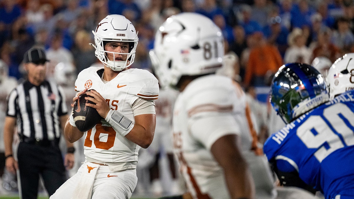 Arch Manning looks down the field