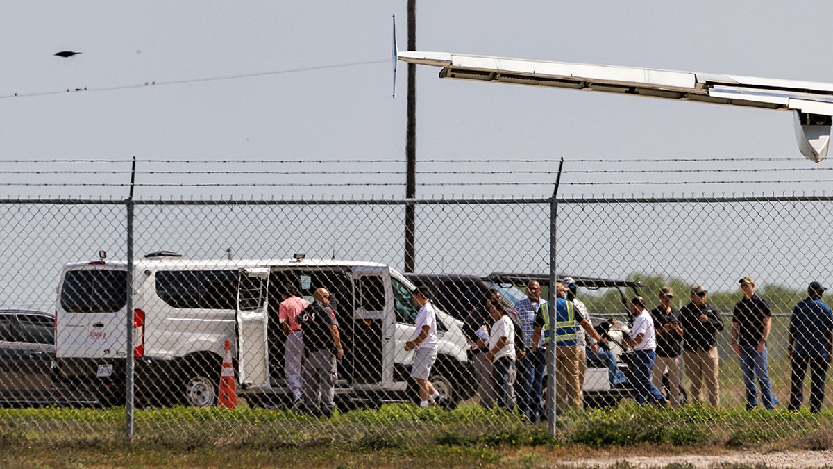 Migrants getting onto a bus