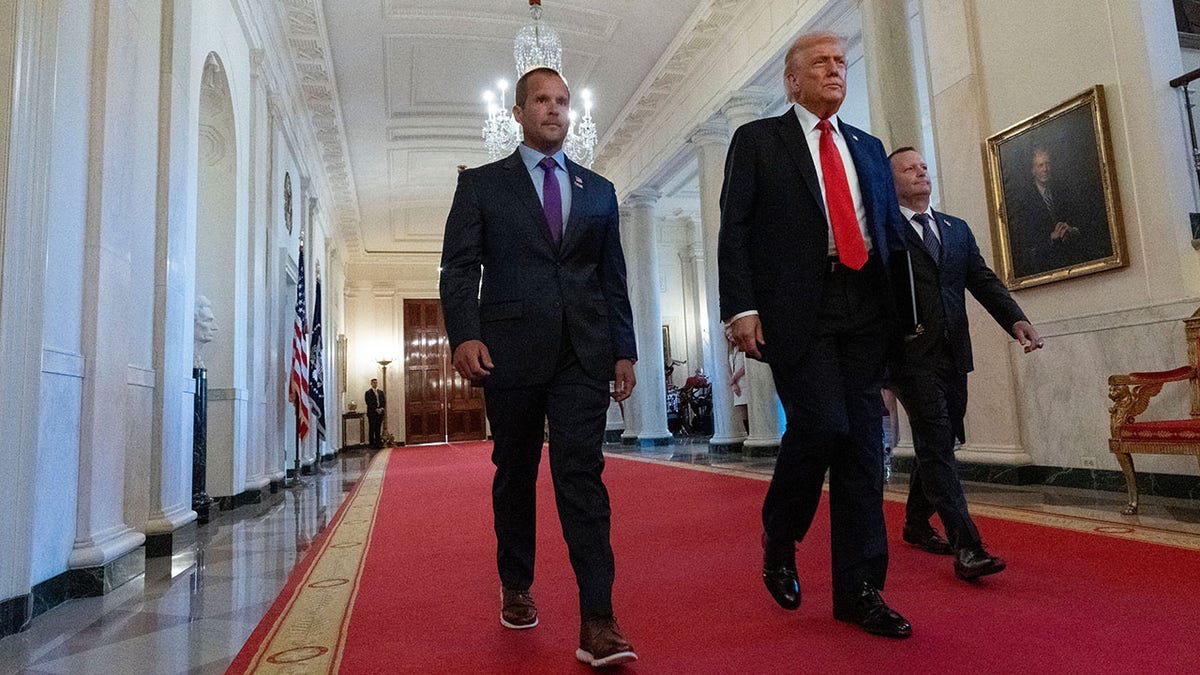 Trump walks with Jay Johnson and Brad Neffendorf