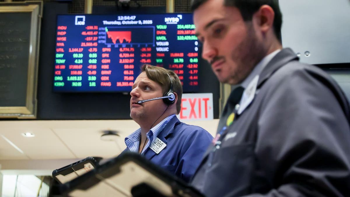 Traders at the New York Stock Exchange as stocks rally after September inflation report.