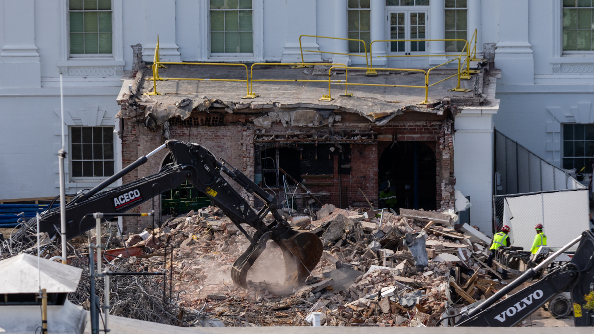 An excavator at the White House clearing rubble