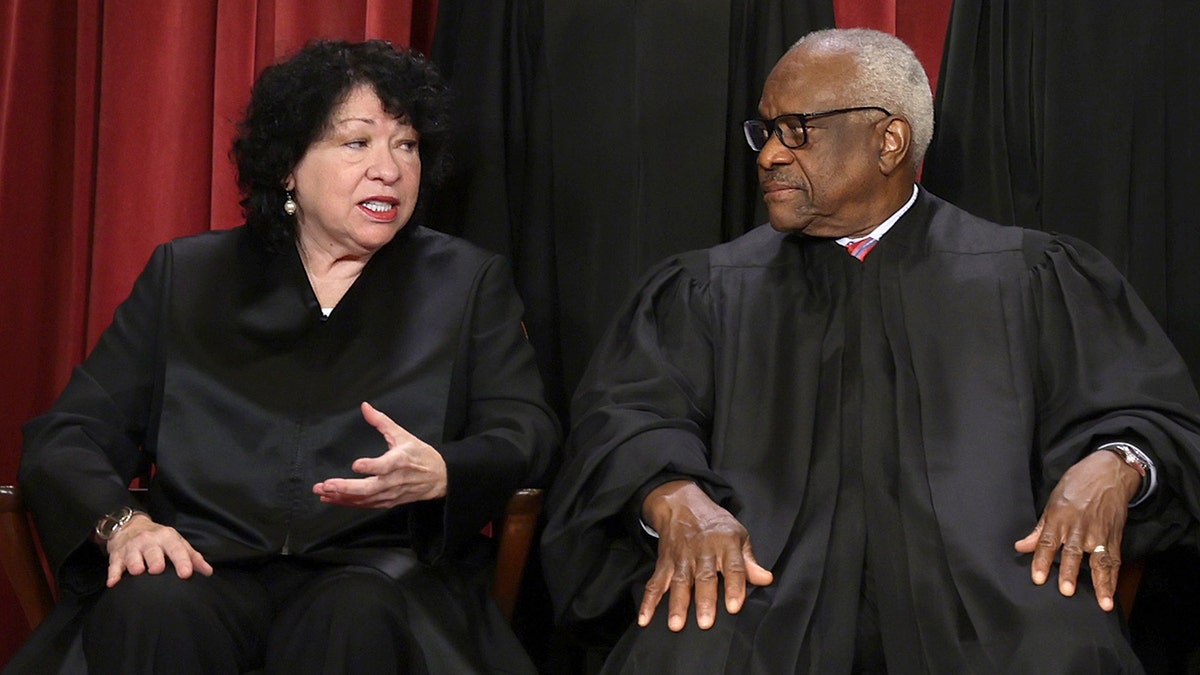 Sonia Sotomayor sitting with Clarence Thomas