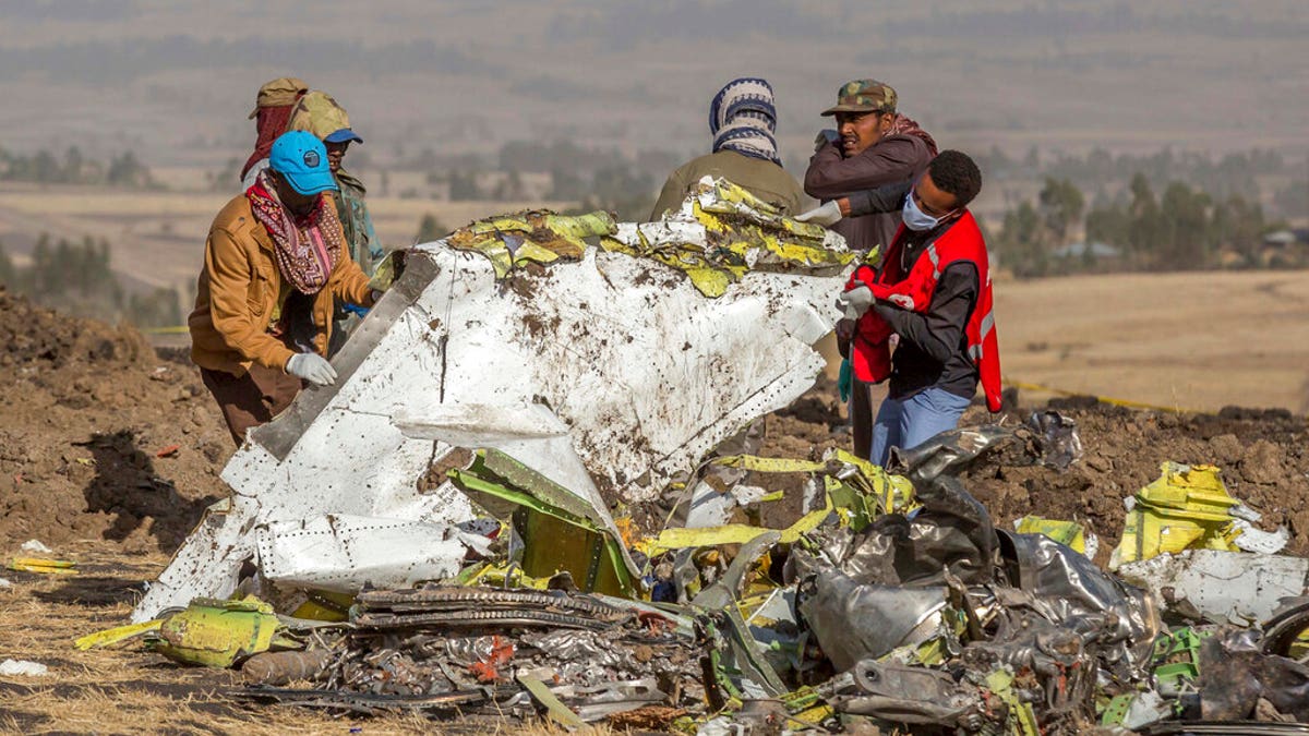 People work at the scene of an Ethiopian Airlines flight crash near Bishoftu, or Debre Zeit, south of Addis Ababa, Ethiopia, March 11, 2019.