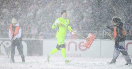 A snowy showdown: Canadian soccer players shovel snow, plows clear field