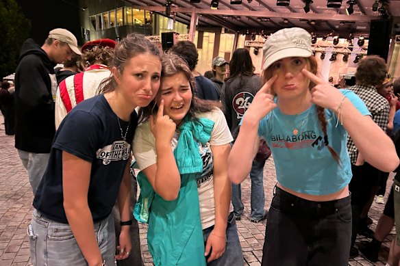 Disappointed fans (from left) Isabel Cook, Lyra Philp and Meg Hill at Federation Square on Friday night.