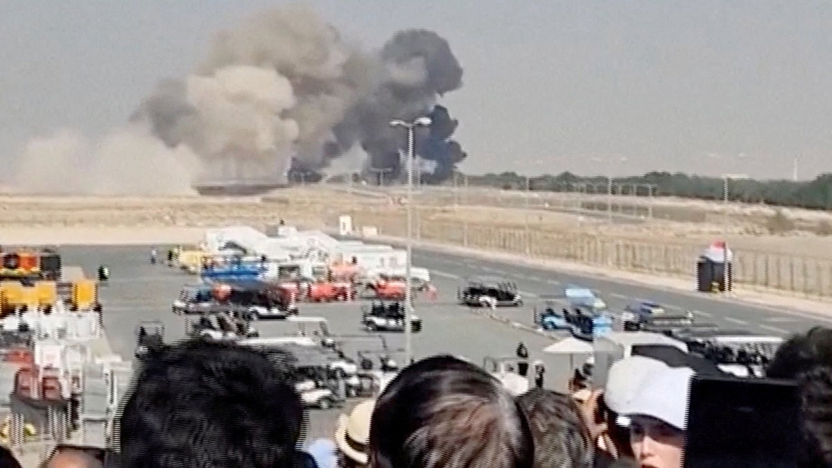 Crowd watches smoke rise into the air following crash at Dubai Air Show