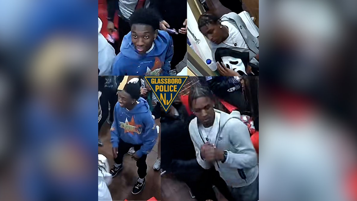 surveillance photo of two male suspects, one in blue sweater, another in grey sweater