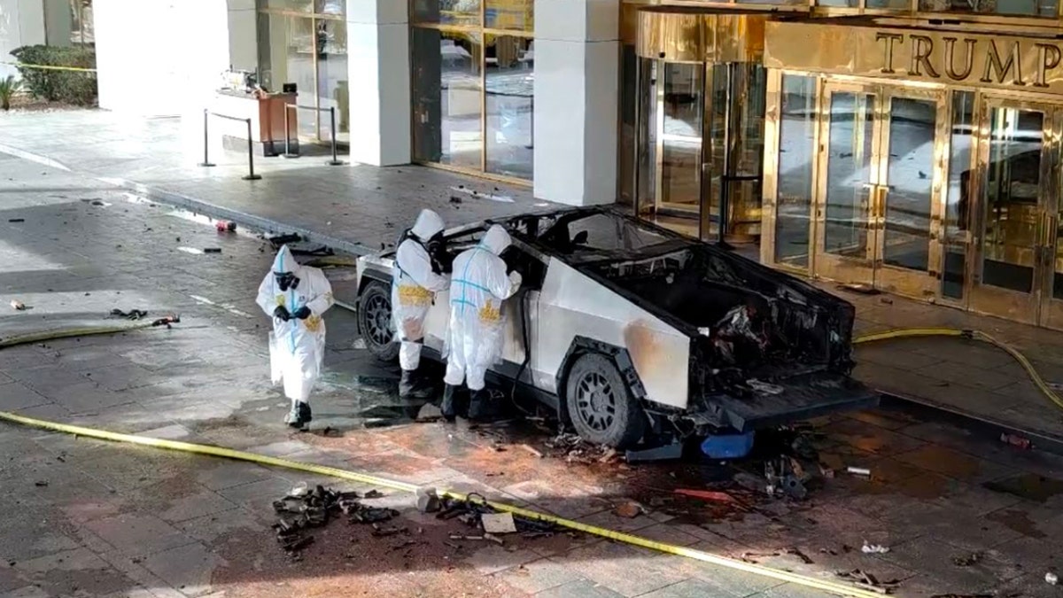 Investigators looking at the blown up Cybertruck. 