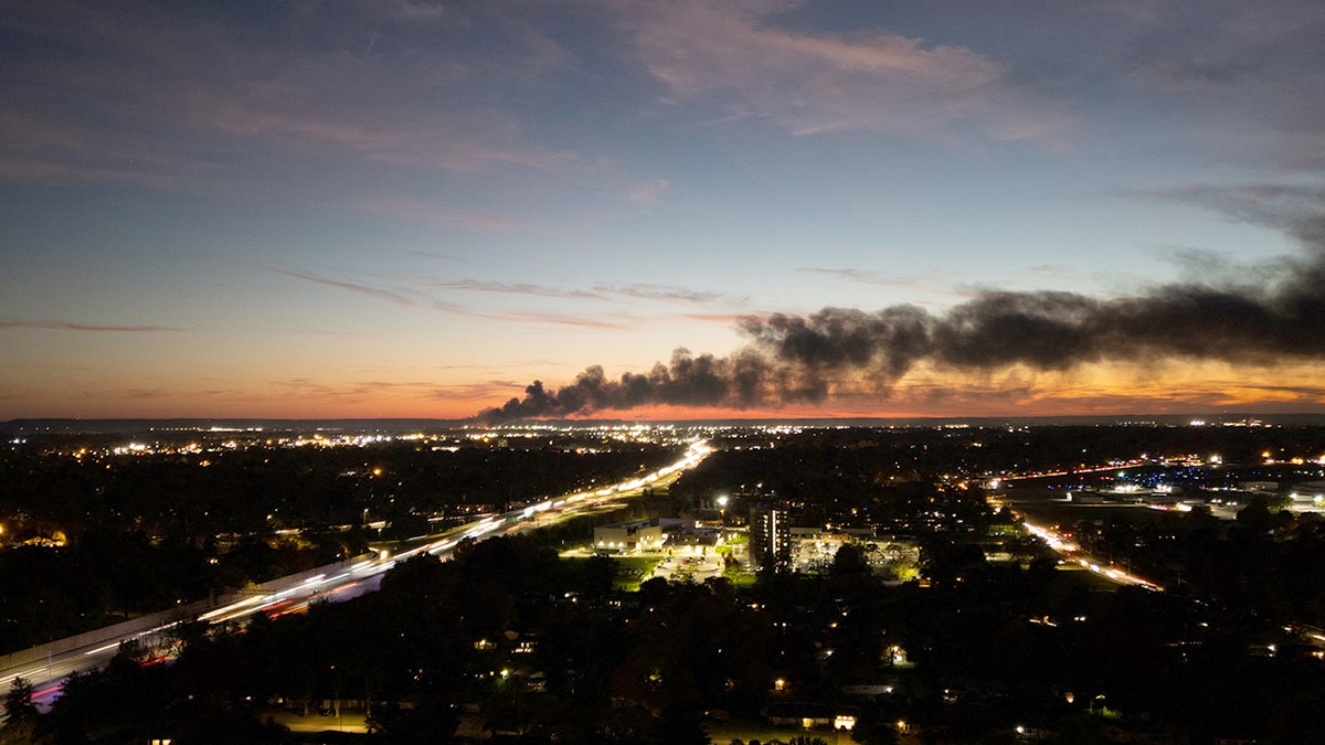 Smoke rises from the site of a UPS cargo plane crash