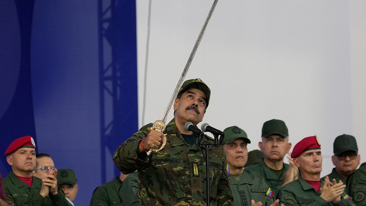 Nicolas Maduro raises sword.