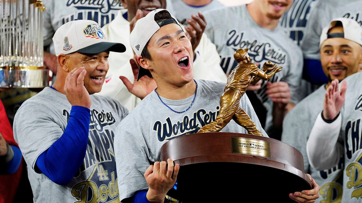 Yoshinobu Yamamoto holds the World Series MVP trophy