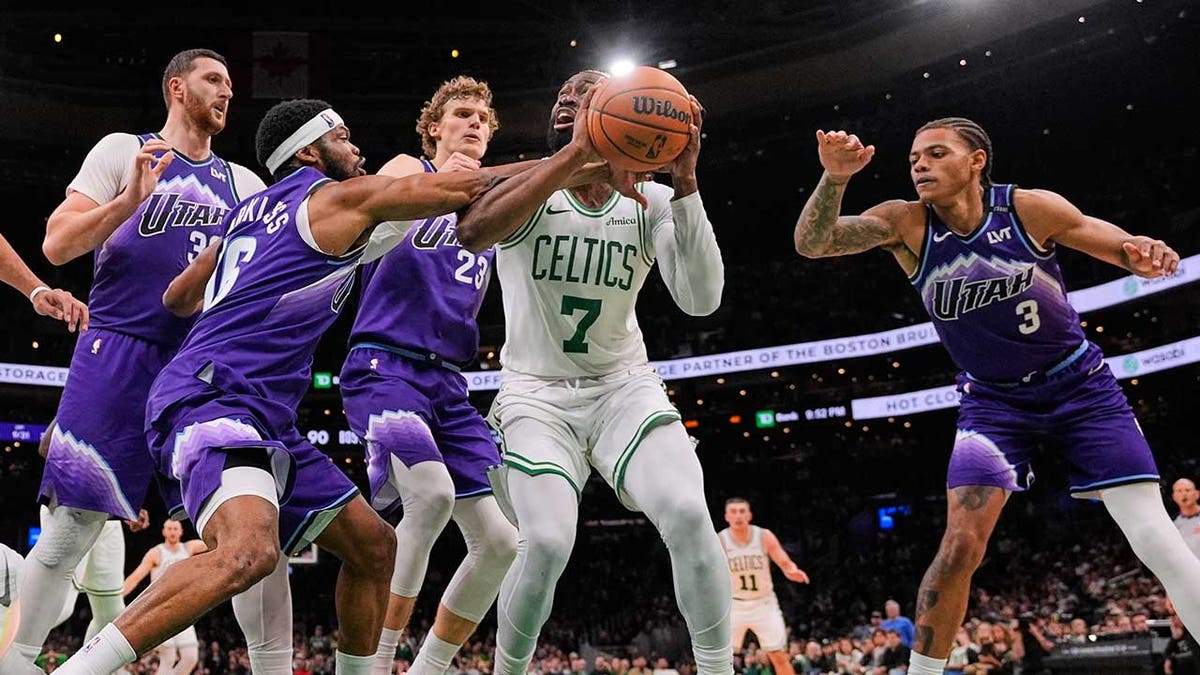 Jaylen Brown surrounded by Jazz players