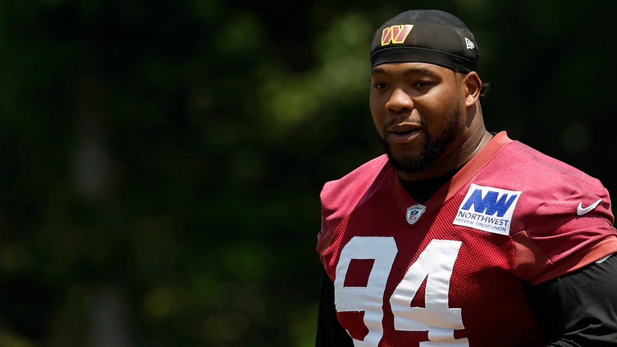 Daron Payne stands on the field at training camp
