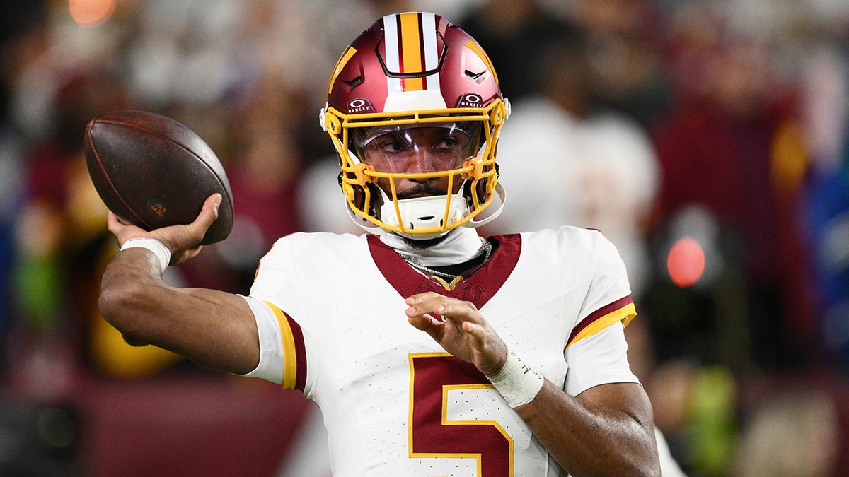 Jayden Daniels warms up for game