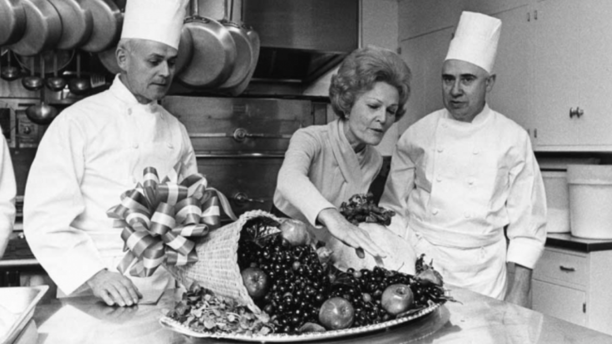 A photo of first lady Pat Nixon with the White House chefs in the kitchen during Thanksgiving.